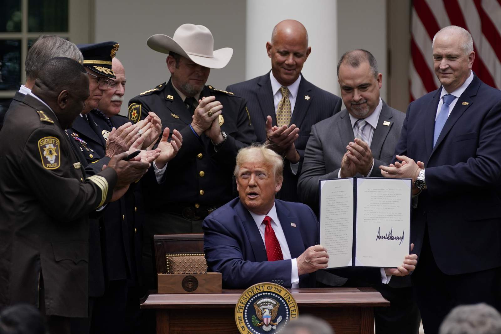 Trump signs order on police reform, doesn't mention racism