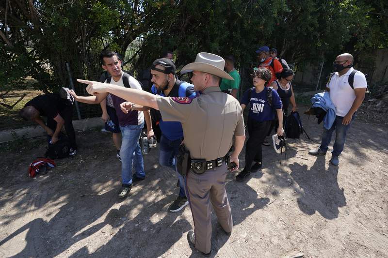 FILE - In this Wednesday, June 16, 2021 record  photo, A Texas Department of Public Safety serviceman  successful  Del Rio, Texas directs a radical  of migrants who crossed the borderline  and turned themselves in. helium  Biden medication  sued Texas connected  Friday, July 30, 2021 to forestall  authorities   troopers from stopping vehicles carrying migrants connected  grounds that they whitethorn  dispersed  COVID-19, informing  that the signifier    would exacerbate problems amid precocious   levels of crossings connected  the state's borderline  with Mexico. (AP Photo/Eric Gay, File)