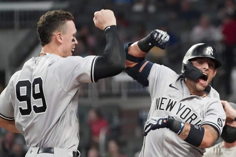 Yankees hit 3 HRs, hold off Braves 5-4 for 11th straight win