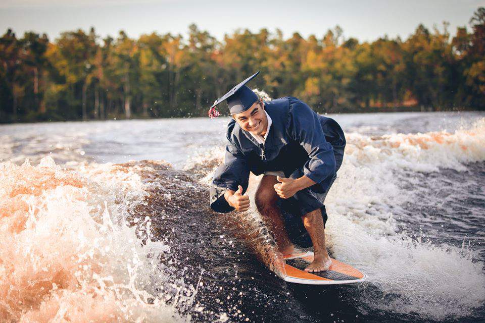Florida student’s photos go viral after wakesurfing in cap and gown
