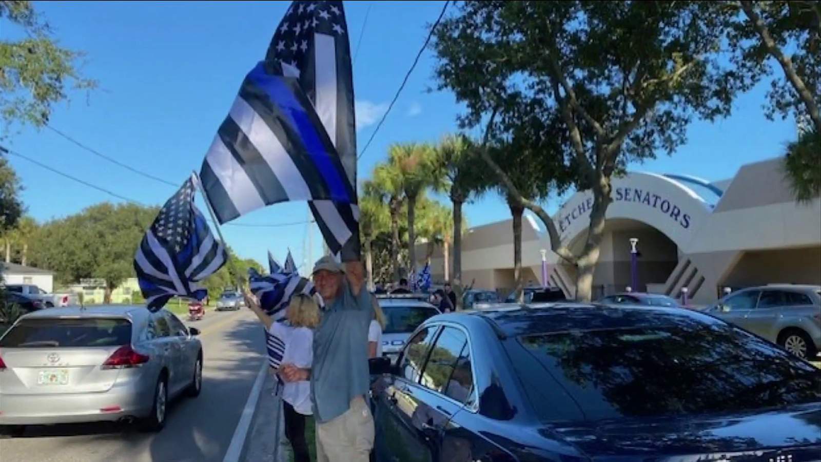 With Thin Blue Line flags & signs, dozens gather outside Fletcher High School