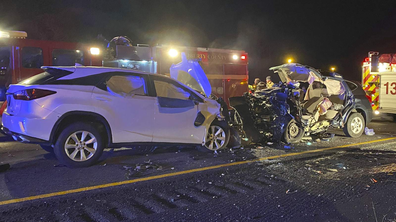 First responders from the Midway Fire Department survey the scene of a fatal accident on Interstate 95, which claimed the lives of multiple people, early Sunday morning in Liberty County, Ga.