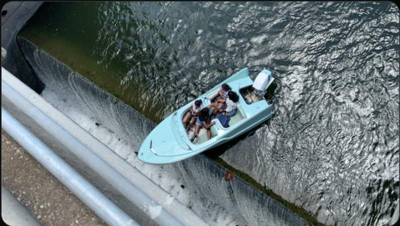 Lake patrol boat saves four people whose boat was going over a Texas dam