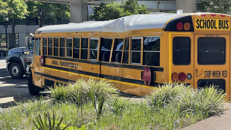 5 kids, 2 adults hospitalized after school bus, car collide downtown