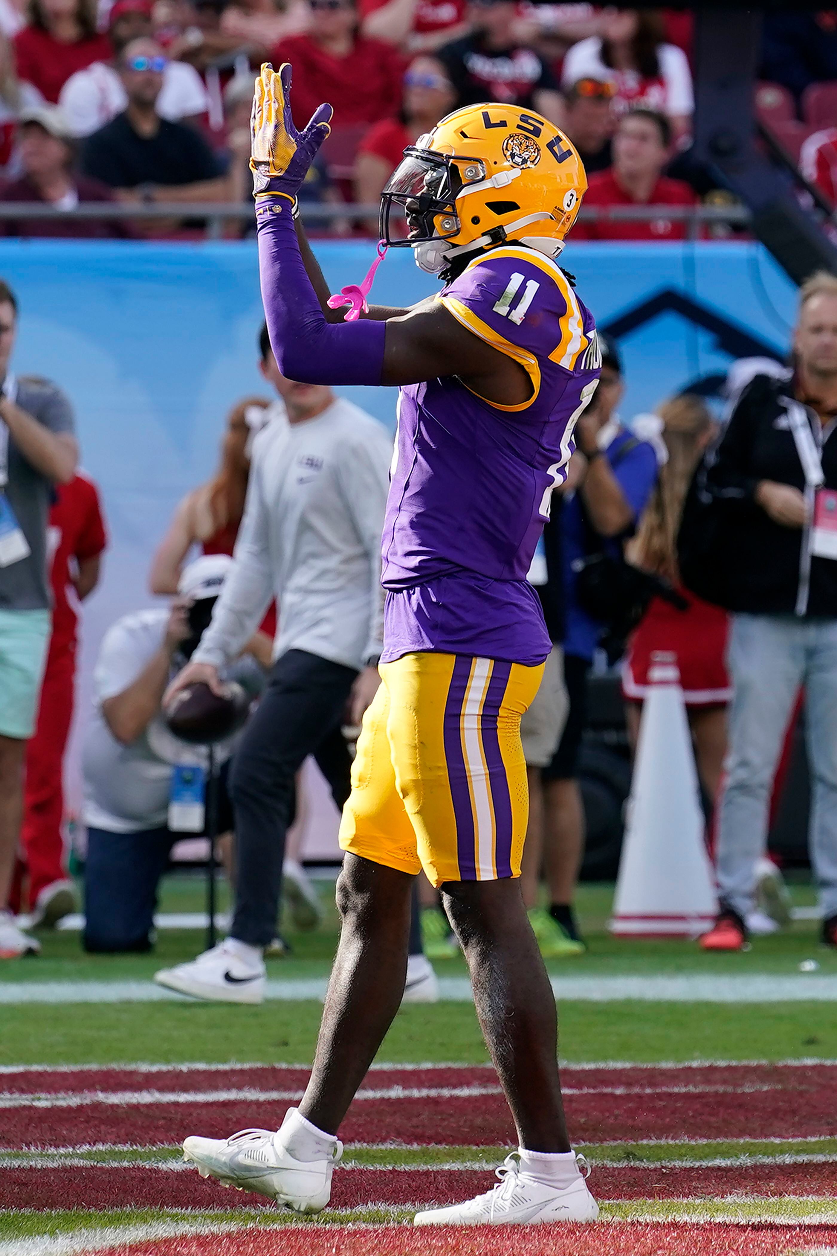 LSU wide receiver Brian Thomas Jr. celebrates after catching a 4-yard touchdown reception during the second half of the ReliaQuest Bowl NCAA college football game against Wisconsin Monday, Jan. 1, 2024, in Tampa, Fla. (AP Photo/Chris O'Meara)