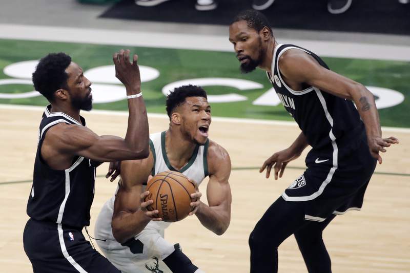 Bucks rally in 4th to beat Nets 124-118, clinch playoff spot