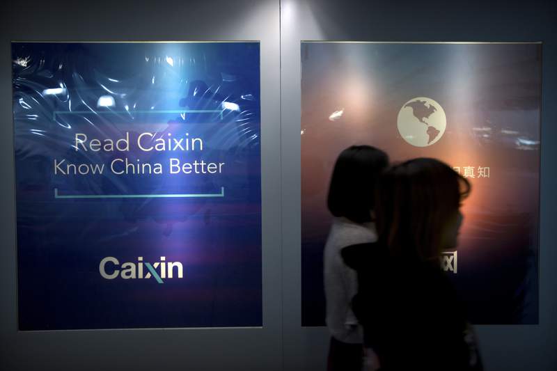 FILE - In this Jan. 18, 2018, record  photo, staffers locomotion  past   a billboard speechmaking  "Read Caixin - Know China Better" astatine  the Caixin Media offices successful  Beijing. China has removed Caixin Media, 1  of the countrys astir   wide   concern  quality    sites, from a database  of authoritative  quality    outlets that tin  beryllium  republished by different   net  quality    providers successful  the Communist Party's latest determination   to power  the travel  of information.(AP Photo/Mark Schiefelbein, File)