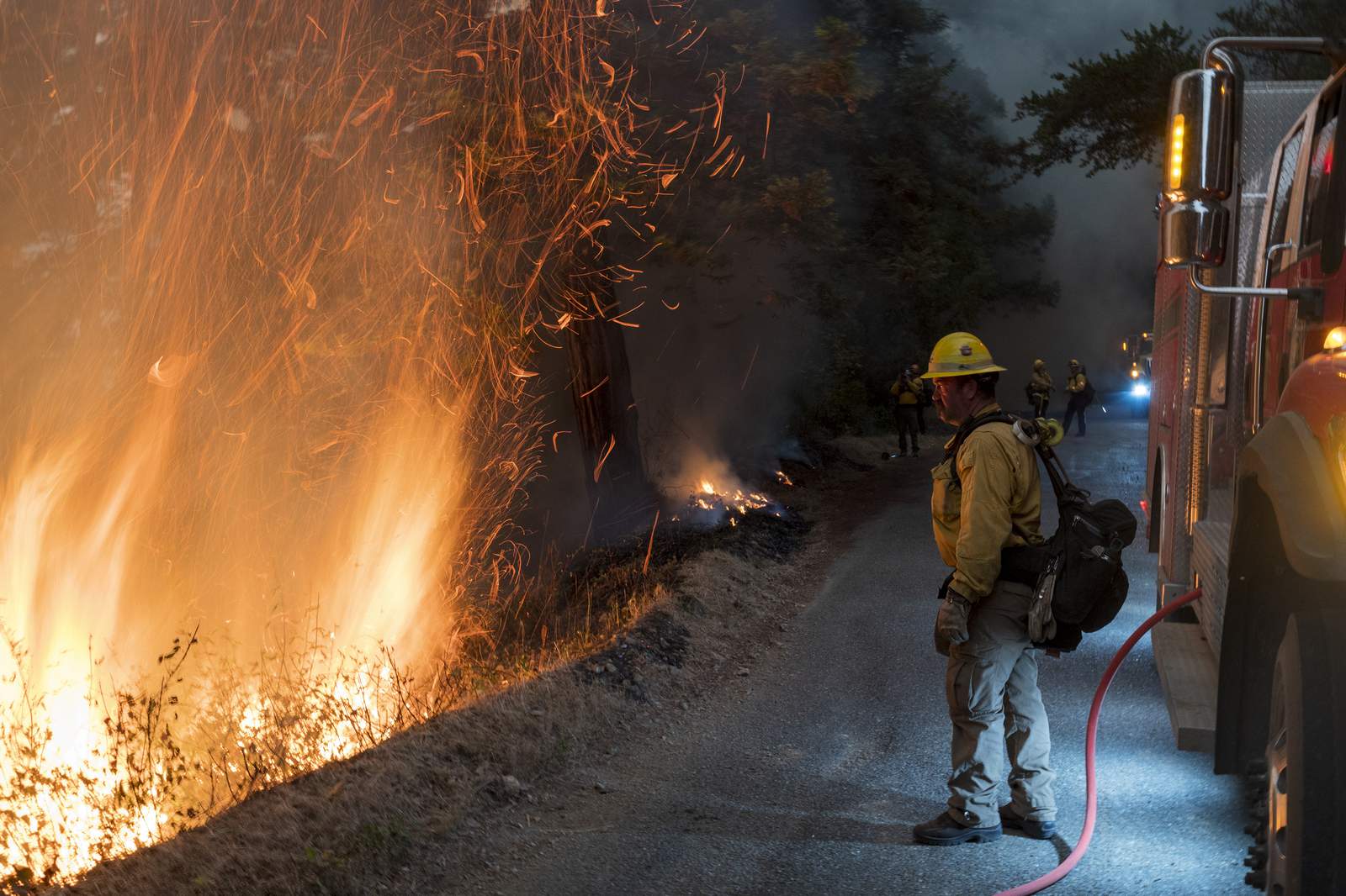 Crews battling California fires head to devastated areas