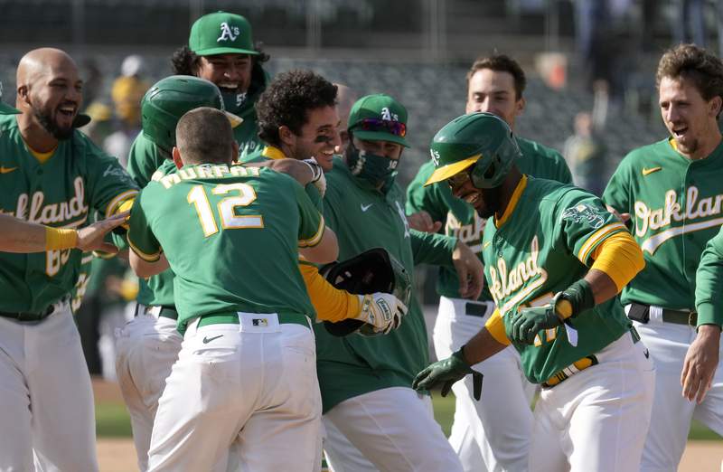 A's extend winning streak to 11, helped by 2 errors in 10th